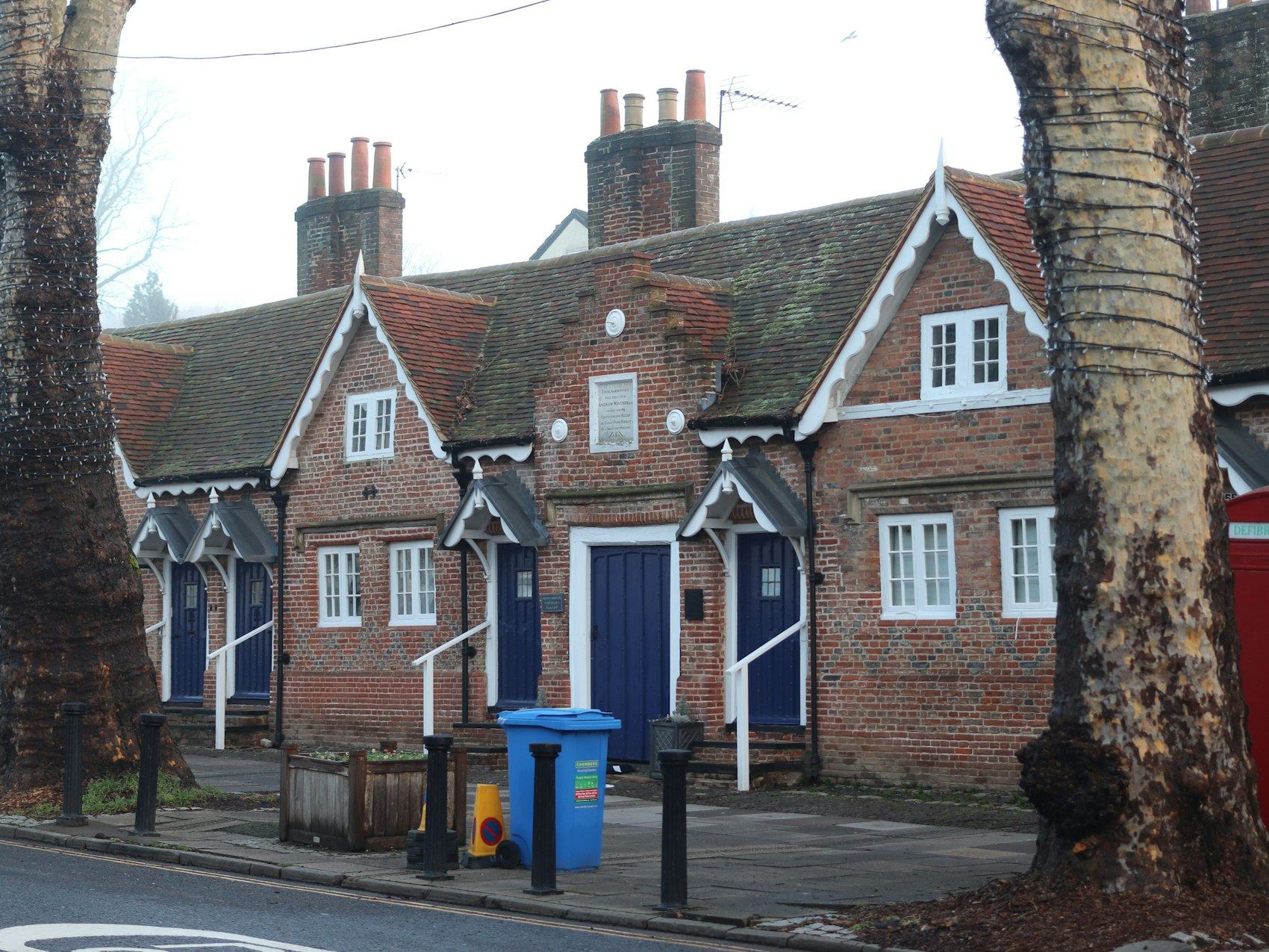 Row of traditional brick houses with blue doors